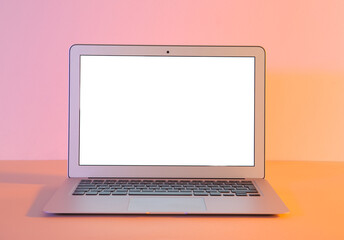 Modern laptop on pink background