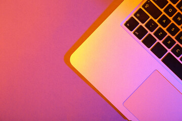 Modern laptop on pink background