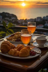 Fotobehang cup of coffee and french croissant on table, balcony with view of beautiful landscape, still life, sea and mountains, resort town, sunset © soleg