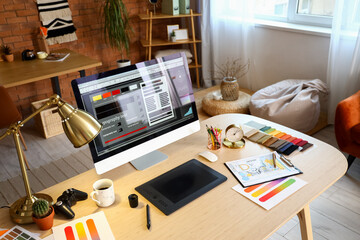 Interior designer's workplace with computer and graphic tablet in office