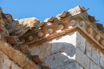 Romanesque ledge with gargoyles on the roof for water drainage. Figures of animals in stone.