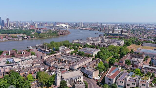 London, England: Aerial view of capital city of UK, Greenwich and skyscraper skyline of Canary Wharf on horizon, sunny summer day with clear blue sky - landscape panorama of United Kingdom from above