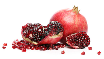 Several ripe pomegranate fruits and an open whole pomegranate, Juicy pomegranate seeds on table,...
