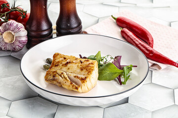 Roasted cod fish steak with salad