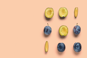 Many fresh plums on orange background