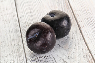 Two ripe sweet black plums