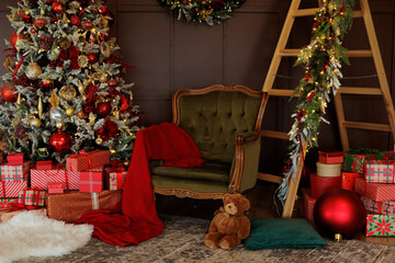 Green armchair, ladder and christmas tree with red gifts in living room