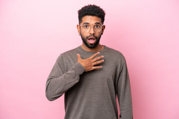 Young Brazilian man isolated on pink background surprised and shocked while looking right