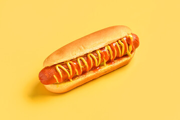 Tasty hot dog with mustard and ketchup on yellow background