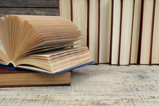 Open book, books on wooden table. Back to school. Education business concept.