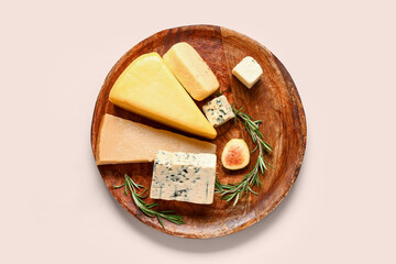 Plate with tasty cheese and fig on beige background