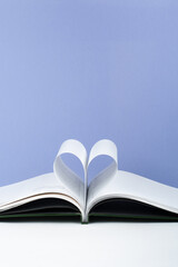 Old open hardback book, page decorate into a heart shape for love in Valentine's. love with open book heart.