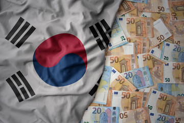 colorful waving national flag of south korea on a euro money background. finance concept