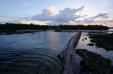 Beautiful landscape. Sunset on the seashore. Wooden bridge on Cloud 9 beach, Siargao Island Philippines.