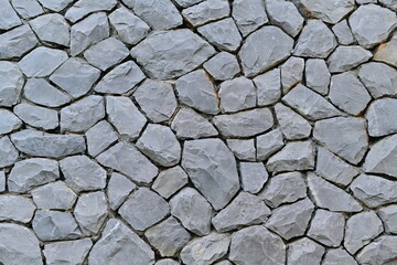 piece of stone wall for background or texture Gray pattern of modern style design. Real stone wall with black and gray color