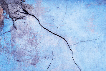 Blue texture grunge background. Old cracked crumbling painted wall