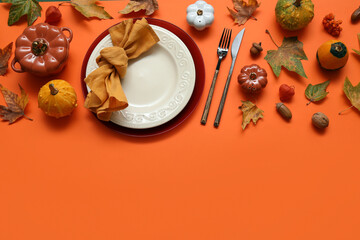 Beautiful table setting for Thanksgiving Day celebration on orange background