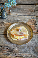 Sandwich with tomato and cheese on a white plate.