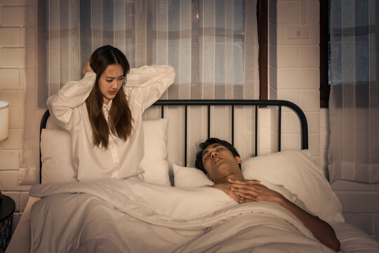 woman distressed by loud snoring at night