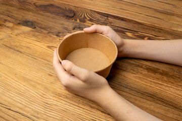 Bowl in Hands, Empty Bowl in Arms on Wooden Background, Vintage Kitchen Tableware Mockup