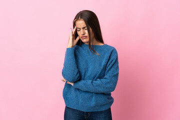 Young Uruguayan woman isolated on pink background with headache