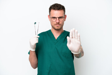 Young caucasian dentist man isolated on white background making stop gesture