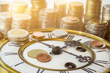 stack of coins on vintage clock