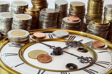 stack of coins on vintage clock