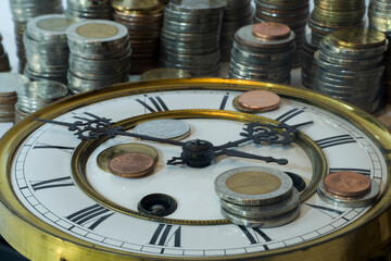 stack of coins on vintage clock