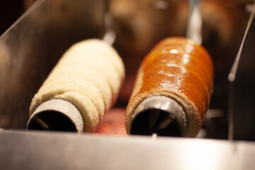 Trdelnik or trdlo on a showcase shop, Kind of spit cake made from rolled dough wrapped around a...