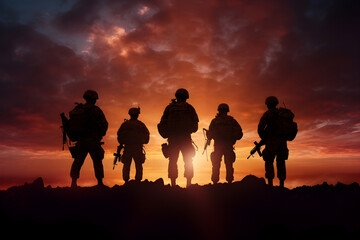 military soldiers' silhouettes standing atop a mountain, gazing at the setting sun. Evokes strength, unity, and a sense of accomplishment