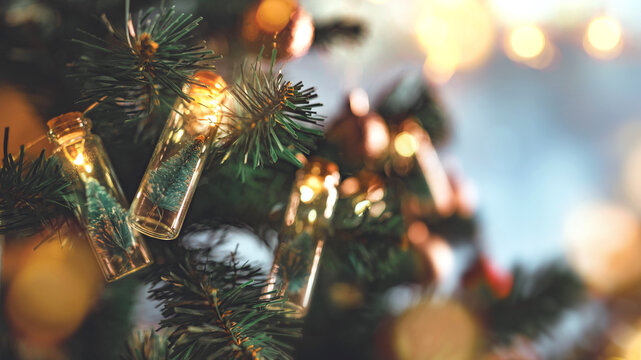 Closeup - Elegant Christmas tree in glass jar with bokeh lights on Christmas tree, Christmas and new year concept.