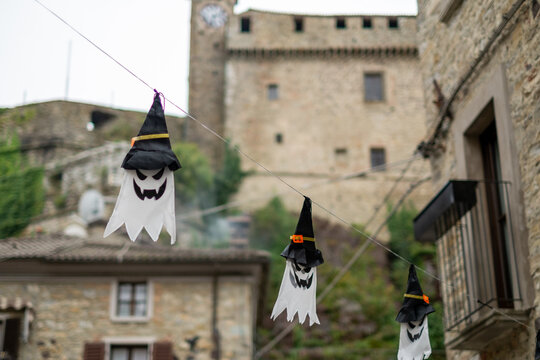 Halloween party. Halloween decorations. Halloween ghosts. Ghosts hanging in the streets of the stone city.