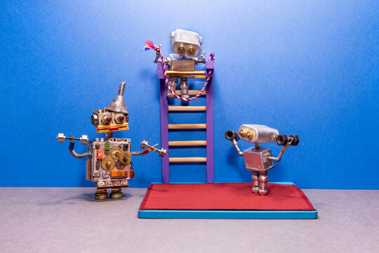 Two robots are engaged in powerlifting in the gym. Barbell, dumbbells, gymnastic mat and wall bars in the background