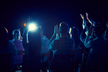 Group of of different people applauding, attending concert, stand up show, cheerfully spending time with jokes and funny stories. Concept of entertainment, fun and joy, concert, performance