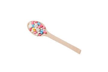 Vitamin capsules in a wooden spoon on a colored background. Pills served as a healthy meal. Drugs, pharmacy, medicine or medical healthycare concept