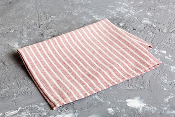 top view with red empty kitchen napkin isolated on table background. Folded cloth for mockup with...