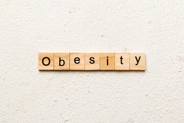 Obesity word written on wood block. Obesity text on cement table for your desing, concept
