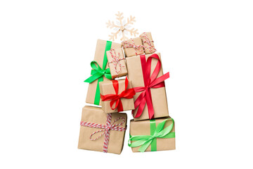 Isolated Christmas tree made of beautifuly wrapped presents on colored background, view from above. New Year gift box minimal concept