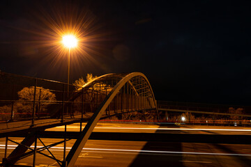 Long Exposure Shot of Highway at Night with Car Light Trails with Bridge