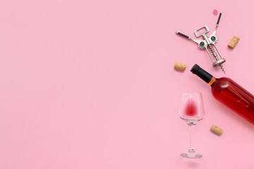 Glass and bottle of exquisite wine with corkscrew on pink background