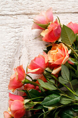 Beautiful roses on wooden background.