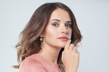 Healthy female face closeup. Young brunette woman with makeup and natural fresh skin portrait