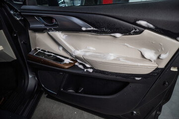 Car door trim in cleaning foam.