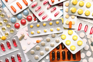 Blister packs with different pills as background