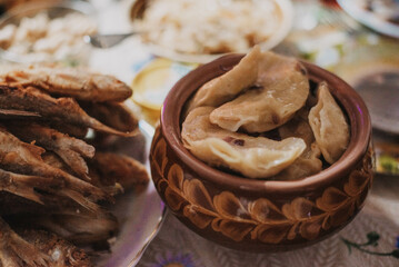 Dumplings with fried onions in a traditional Ukrainian plate. 