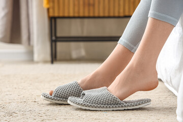 Young woman in soft slippers at home, closeup