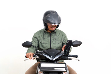 Asian man checking his phone while driving motorcycle. Isolated on white background