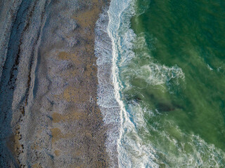 Sand and green waves texture seen from above texture