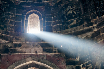 Beam of light from window of ancient indian tomb Bada Gumbad in New Delhi, India, white ray of light